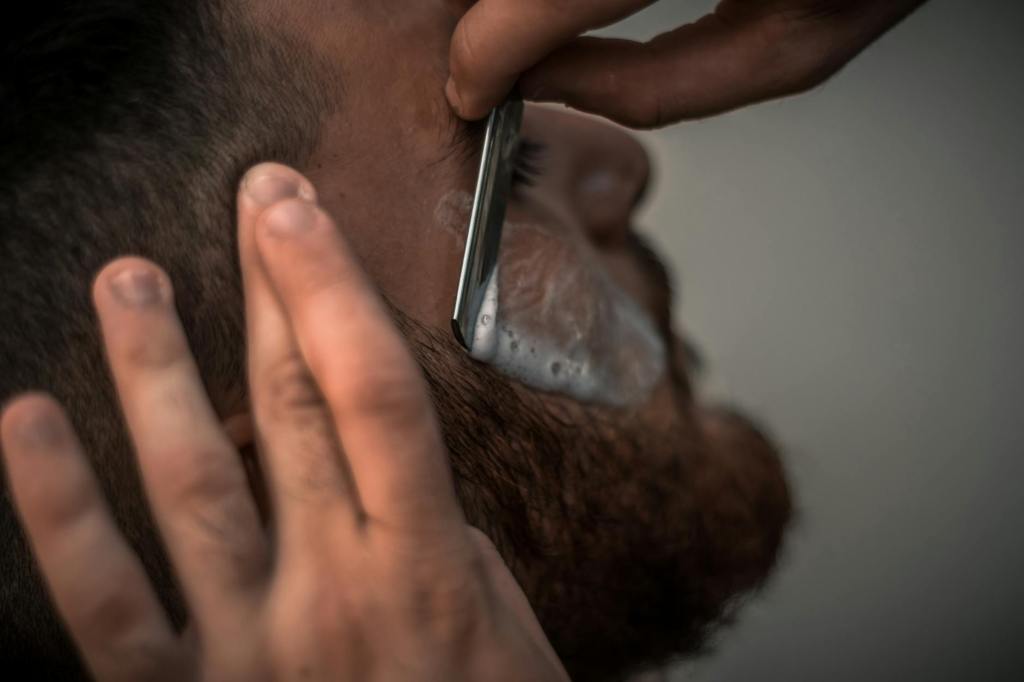 Barber shaving a bearded man